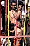 Devotees in the cage leading to the inner sanctum of the Arulmigu Dhandayuthapani Swamy Temple.