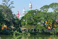 View to the Jagannath Bari, a 19th century 4-storey octagonal Hindu temple across Rajbari Lake near the Ujjayanta Palace, Agartala.