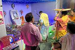 A Hindu “puja”, a ceremony to honour a recently deceased guru, whose photo is displayed; in a temporary temple, just behind Veda Homestay in Agartala.