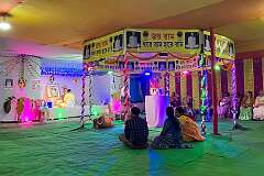 A Hindu “puja”, a ceremony to honour a recently deceased guru, whose photo is displayed; in a temporary temple, in Agartala.