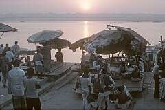 Fortune tellers under their parasols, at sunrise over the Ganges river in Varanasi.