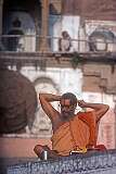 A man binding his hair along the Ganges river in Varanasi.