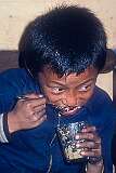 Kunzong Dorjee, a young Bhutanese boy, eating at Jangsa Gompa, Kalimpong.