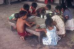 Young children writing on slates in St John Primary School on Abaiang atoll.
