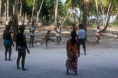 Boys and men playing a ball game in Kariatebike, the largest village on Abemama atoll.