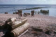 Carrying bags of copra to the beach in Taribo, to be taken by dinghy to the ship “Nei Momi“ anchored offshore.