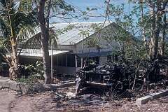 A house and wrecked truck in Tabwewa (Tabewa).