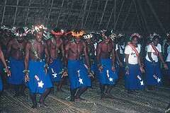 Singing and dancing with costume designs representing Halley's Comet, in the Maneaba “Te Nanoraoi” in Kuma.