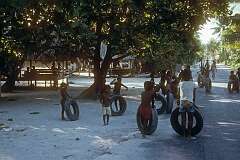 Children playing with tyres, Betio.