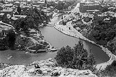 Sarajevo, Bosnia - The view to the Miljacka river with the swimming pool, the Vijećnica City Hall and the city.
